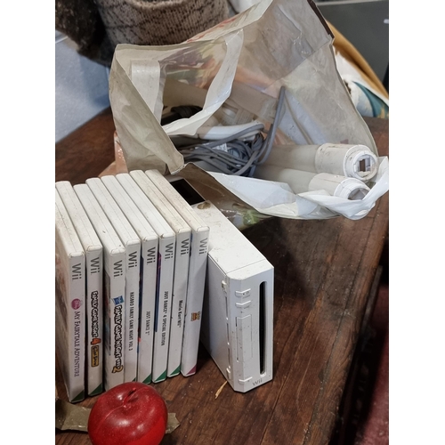 835 - A Ninendo Wii console with a number of accessories. including a pair of Karting controller wheels, t... 