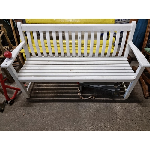 850 - A good sized, three seater wooden garden bench with a painted white finish.