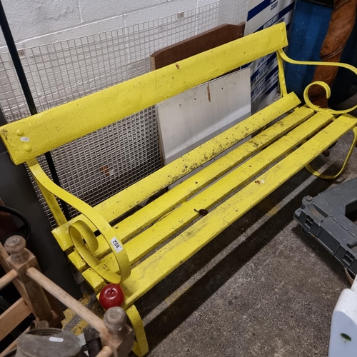 852 - A wonderful wooden antique garden bench, with a wrought iron frame and cheerful yellow painted finis... 