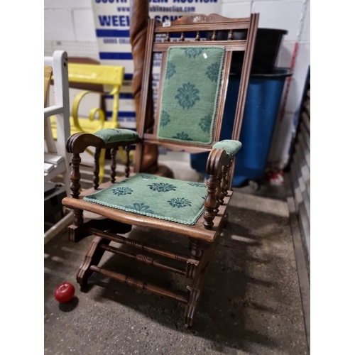 856 - A beautiful vintage rocking chair, with carved armrests, turned supports and lovely padded green uph... 