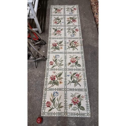 864 - A delightful hand made crotchet rug with floral pattern on a cream ground.