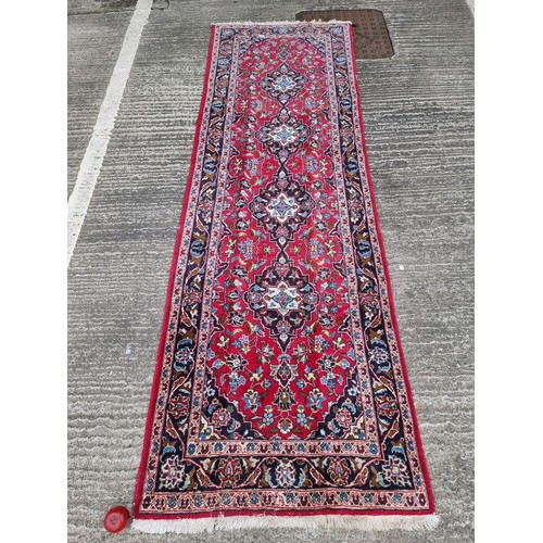 702 - Star lot : A fabulous hand knotted, hand made wool hall runner rug in jewel tones of red, green and ... 