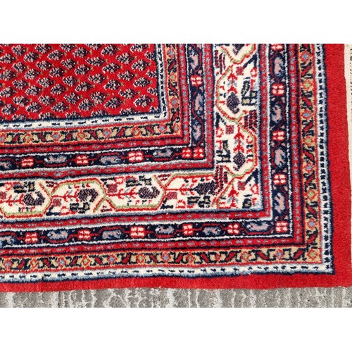 703 - Star lot : A fabulous hand knotted, Indian wool rug from the Sarough Mir Province, in jewel tones an... 