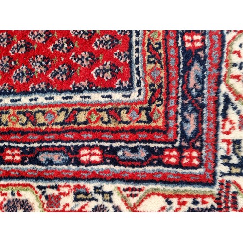 703 - Star lot : A fabulous hand knotted, Indian wool rug from the Sarough Mir Province, in jewel tones an... 