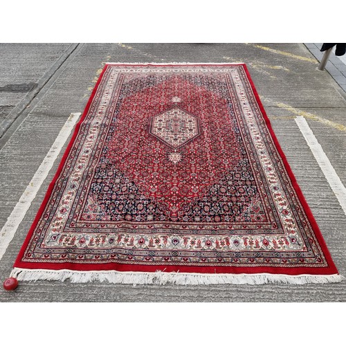 705 - Star lot : A fantastic handknotted wool persian rug from Bidjar, India in an ornate pattern in jewel... 