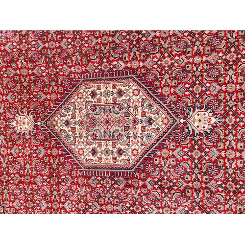 705 - Star lot : A fantastic handknotted wool persian rug from Bidjar, India in an ornate pattern in jewel... 