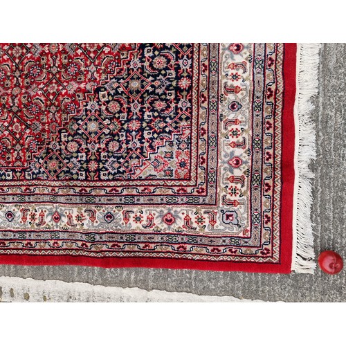 705 - Star lot : A fantastic handknotted wool persian rug from Bidjar, India in an ornate pattern in jewel... 