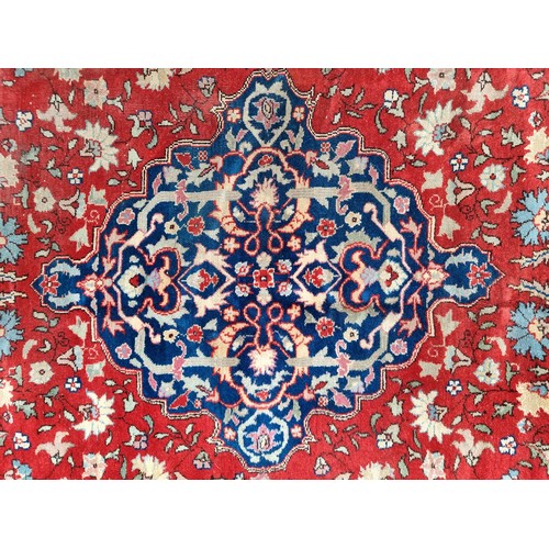 707 - A stunning Persian and knotted rug in patterns of red, cream and blue made in Tabriz, Iran. Mm: 300 ... 