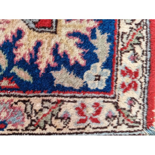 707 - A stunning Persian and knotted rug in patterns of red, cream and blue made in Tabriz, Iran. Mm: 300 ... 