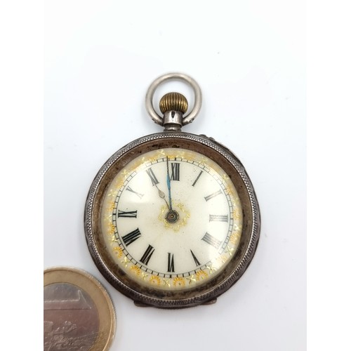 An antique 0.935 silver pocketwatch with enameled Roman Numeral face with handpainted gilt detail. A