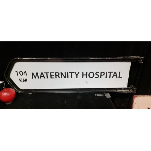 744 - A heavy road sign reading Maternity Hospital 104 km in a cast metal frame. . Seems like a long way a... 