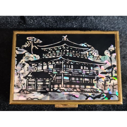 240 - Two vintage items, including a Japanese powder compact and music box with a mother of pearl temple s... 