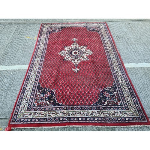 74 - Star lot : A fabulous large hand made and hand knotted persian rug in shades of red, blue and green.... 