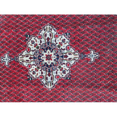 74 - Star lot : A fabulous large hand made and hand knotted persian rug in shades of red, blue and green.... 