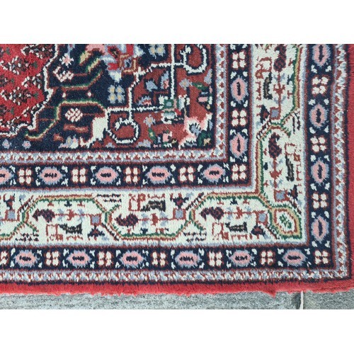 74 - Star lot : A fabulous large hand made and hand knotted persian rug in shades of red, blue and green.... 