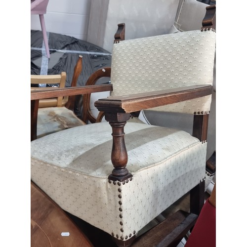 482 - A pair of antique oak heavy quality armchairs, with high arms, turned supports, stud detailing and u... 