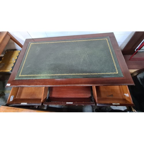 731 - Star Lot : A handsome twin pedestal desk with tooled green leather inlay, ample storage by way of tw... 