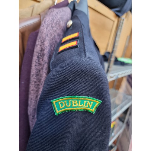 389 - A vintage Irish uniform jacket by J.I. & Son with epaulettes, 'Dublin' patches to shoulders, and but... 