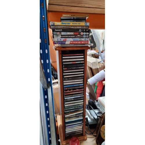 816 - A wooden tower CD rack including a collection of CDs and DVDs, Lots of U2 in this lot. Also included... 