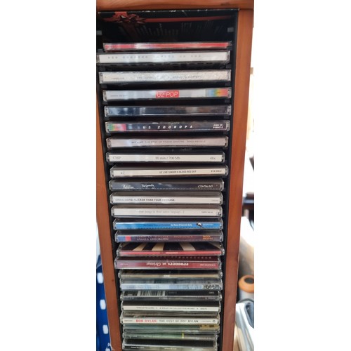 816 - A wooden tower CD rack including a collection of CDs and DVDs, Lots of U2 in this lot. Also included... 