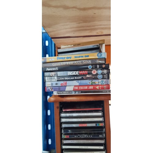 816 - A wooden tower CD rack including a collection of CDs and DVDs, Lots of U2 in this lot. Also included... 