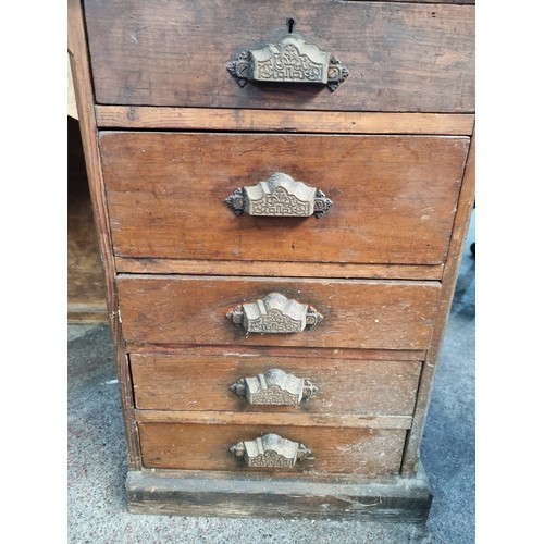 831 - An antique, 19th century ships desk. A large example with ten drawers featuring unusual cast metal c... 