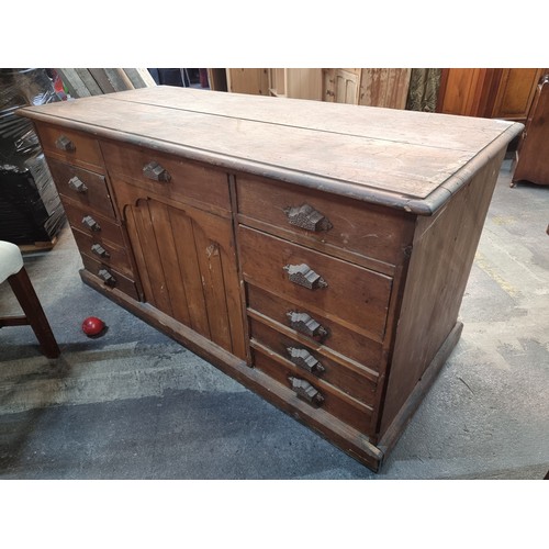 831 - An antique, 19th century ships desk. A large example with ten drawers featuring unusual cast metal c... 