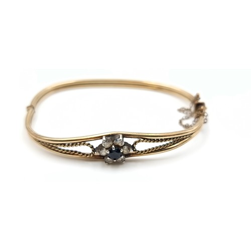 12 - A collection of three vintage bangle bracelets, consisting of a 9 carat Gold floral gem stone bracel... 