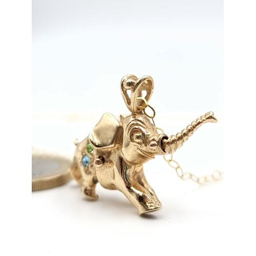 30 - Star Lot: An exquisite 9 carat Elephant pendant, featuring an articulated trunk and set beautifully ... 