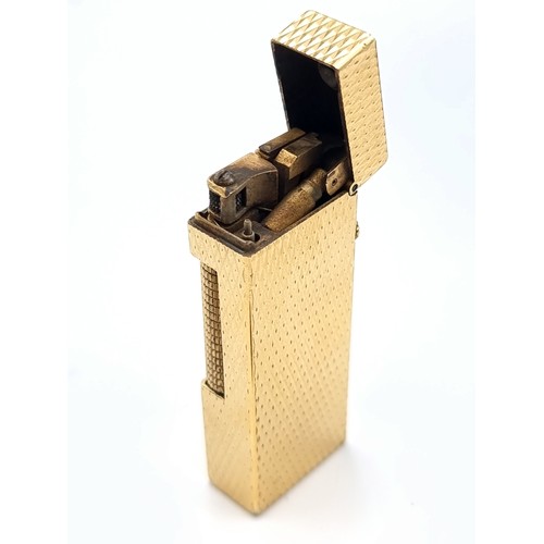 46 - A Dunhill Rollagas lighter, featuring a nicely detailed gold machine cut finish. Comes in original p... 