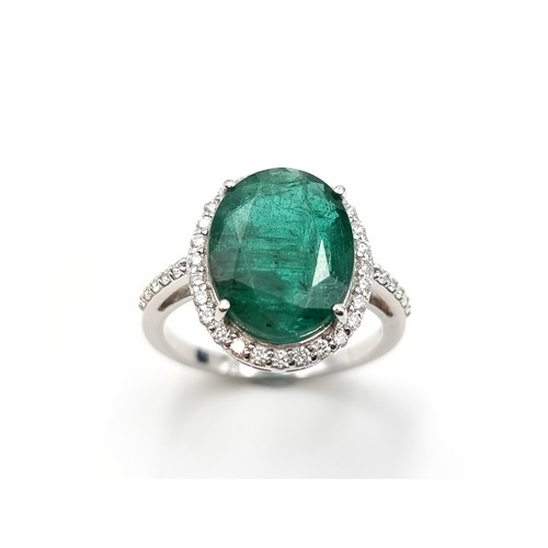 438 - Super Star Lot: An exceptional example of an oval Emerald and Diamond 14 carat white Gold ring, whic... 