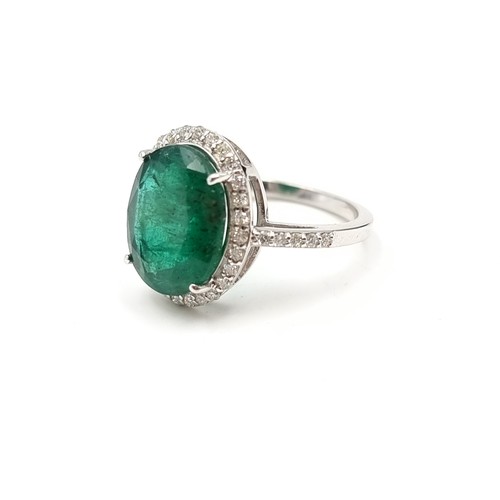 438 - Super Star Lot: An exceptional example of an oval Emerald and Diamond 14 carat white Gold ring, whic... 