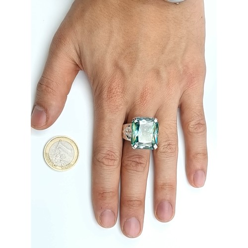 441 - A show stopping rectangular gents Ocean Blue Moissanite ring, which features a vintage fleur di lis ... 