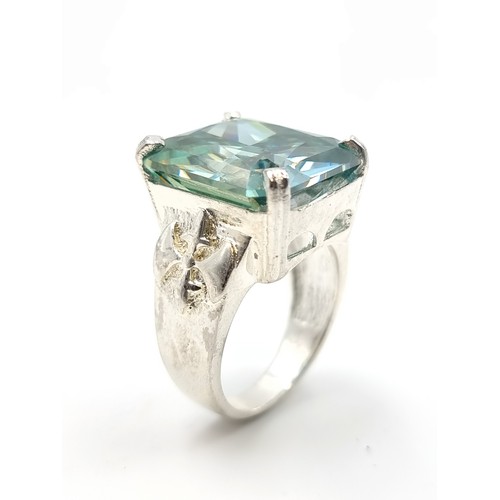 441 - A show stopping rectangular gents Ocean Blue Moissanite ring, which features a vintage fleur di lis ... 