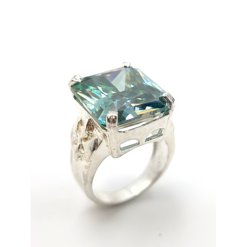 441 - A show stopping rectangular gents Ocean Blue Moissanite ring, which features a vintage fleur di lis ... 