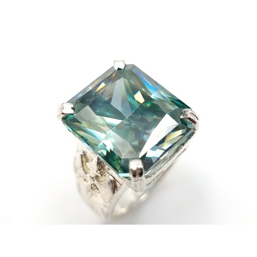 441 - A show stopping rectangular gents Ocean Blue Moissanite ring, which features a vintage fleur di lis ... 