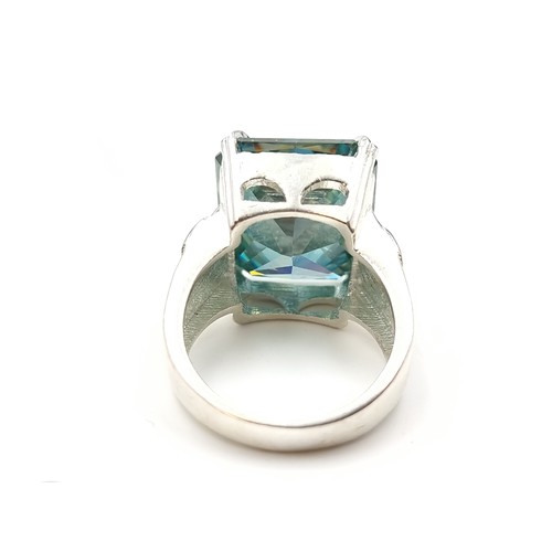 441 - A show stopping rectangular gents Ocean Blue Moissanite ring, which features a vintage fleur di lis ... 