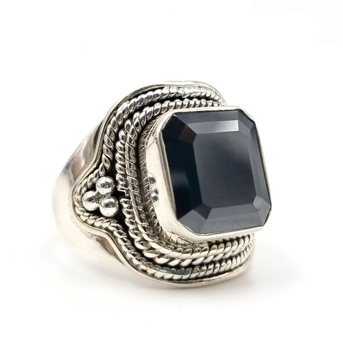 449 - A fine example of a Gents Onyx Moissanite rectangular cut ring, of 6 carats and set beautifully in s... 