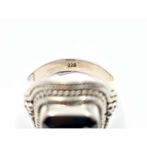 449 - A fine example of a Gents Onyx Moissanite rectangular cut ring, of 6 carats and set beautifully in s... 