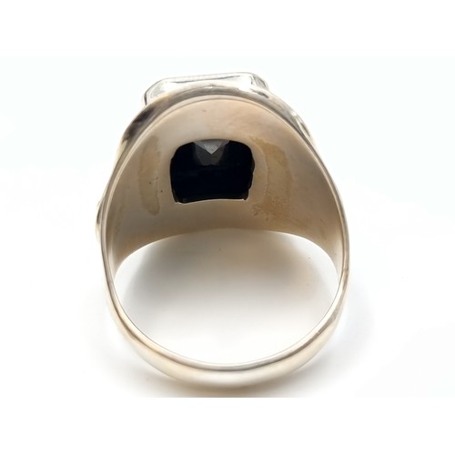 449 - A fine example of a Gents Onyx Moissanite rectangular cut ring, of 6 carats and set beautifully in s... 