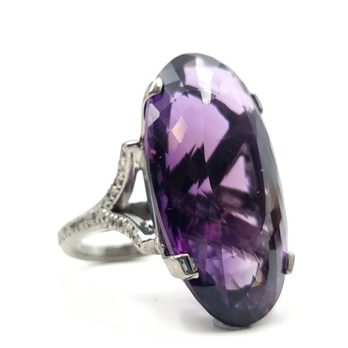 445 - Star lot : A rare huge Bolivian Amethyst ring, of an immense 60 carats with .55 carats of Diamonds t... 