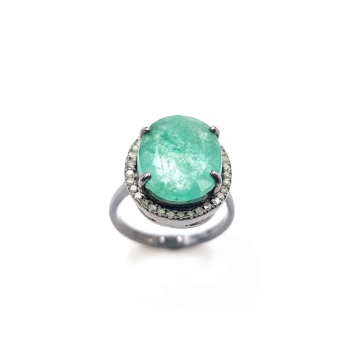 446 - A beautiful oval cut Emerald and Diamond ring, of a centre stone 6.7 carats and a halo surround of .... 