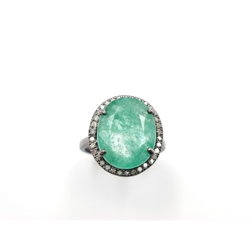 446 - A beautiful oval cut Emerald and Diamond ring, of a centre stone 6.7 carats and a halo surround of .... 