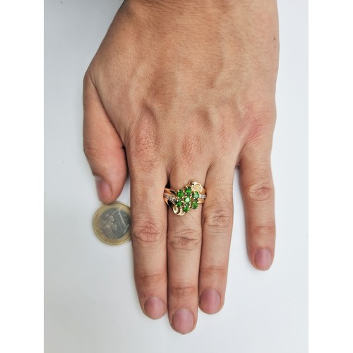 668 - Star lot : A fabulous 14 carat gold vintage seven stone Diopside and Diamond dress ring, with an att... 