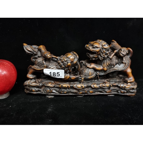 185 - A profusely carved antique Chinese display featuring four sparring Foo dogs. This piece features bot... 