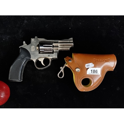 186 - A delightful gas lighter in the form of a pistol revolver based on the R77 combat handgun accompanie... 