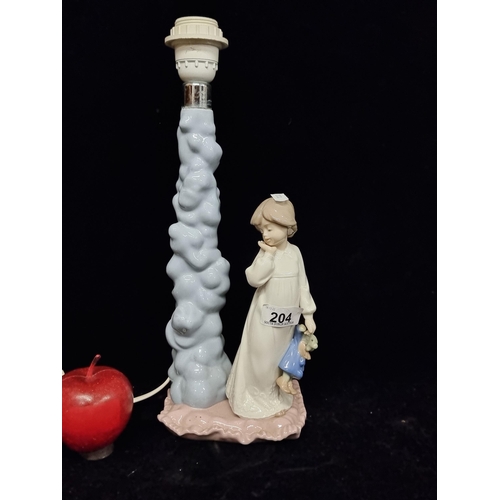 204 - A NAO Lladro handmade porcelain lamp base titled Daisa featuring a young girl holding a clown toy, a... 