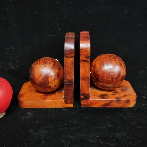 277 - A pair of sleek carved wood ball bookends.