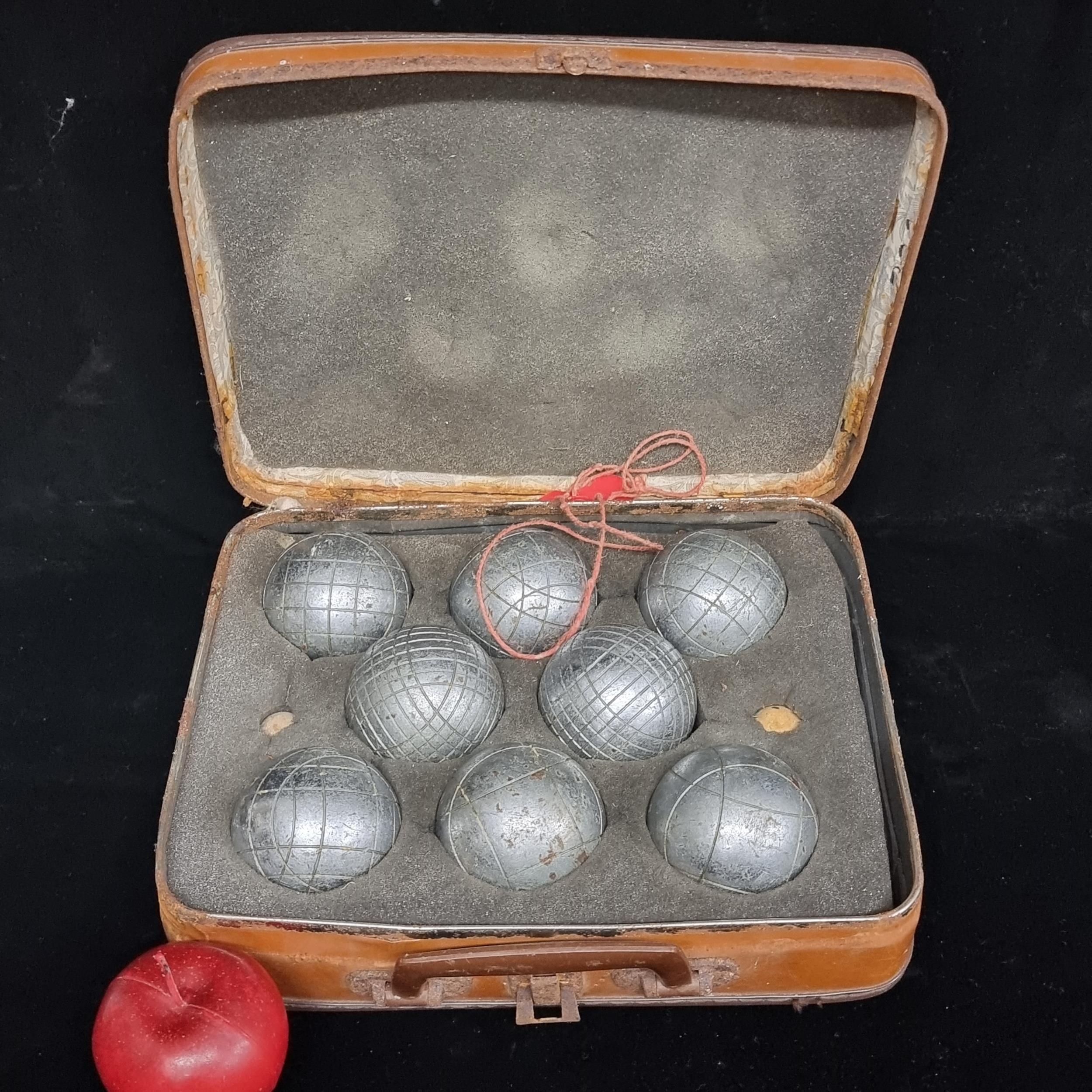 A very cool, vintage set complete with eight iron boules and a brown ...