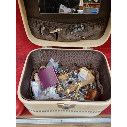 397 - A cream travel trunk containing a a 5 shillings, George VI festival of Britain crown in presentation... 